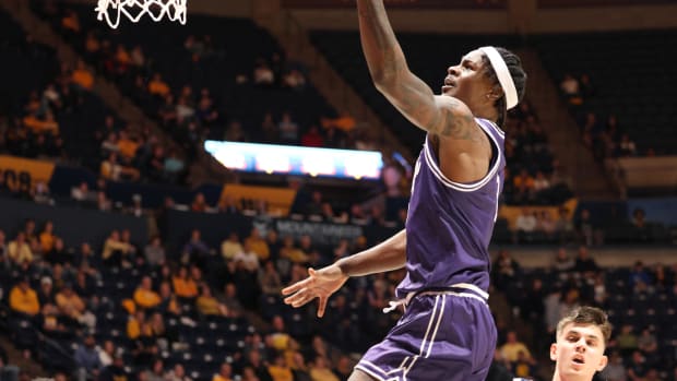 TCU forward Emanuel Miller gets the easy lay-in following a West Virginia turnover. Miller led the Horned Frogs with 21 points.